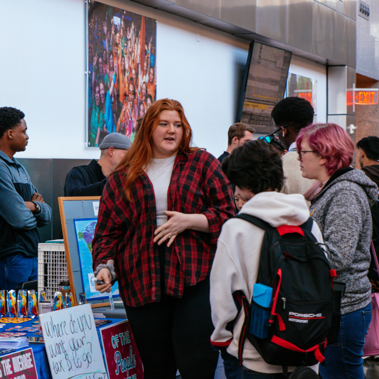 A student organization representative talking to students at the Student Involvement Fair.