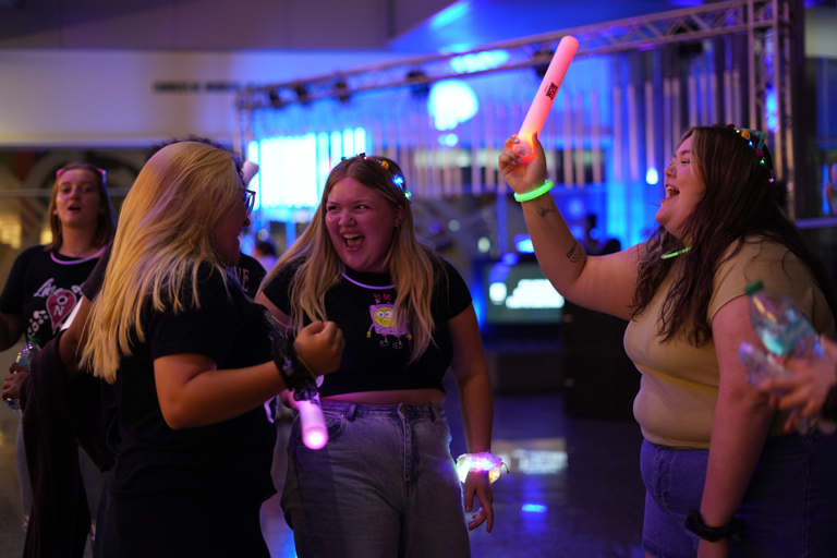 A group of women smiling and partying at Light up the Night at the IU Indianapolis Campus Center.