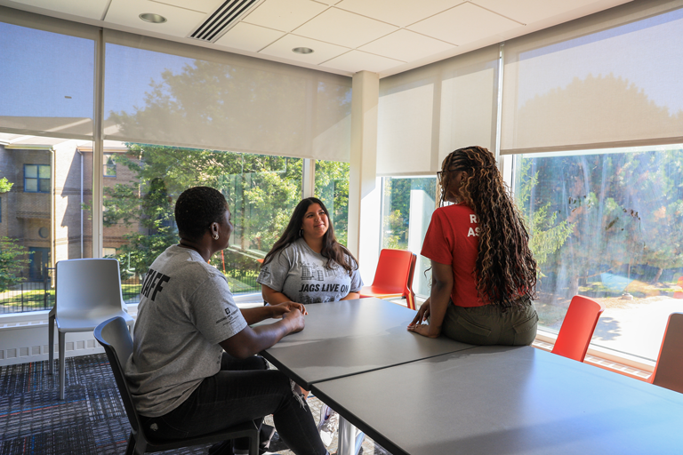 Two RAs sitting and talking.