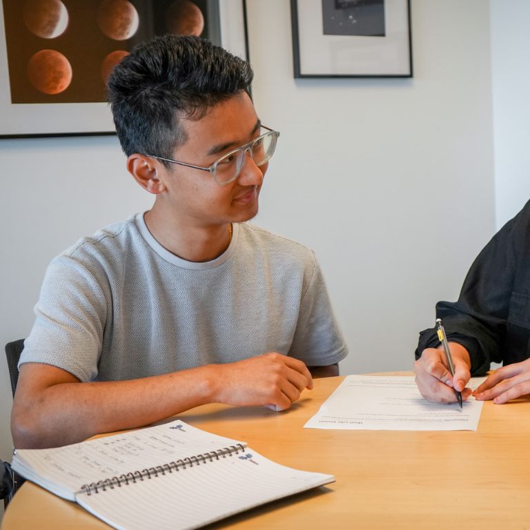 Student getting assistance with his paper from the University Writing Center.