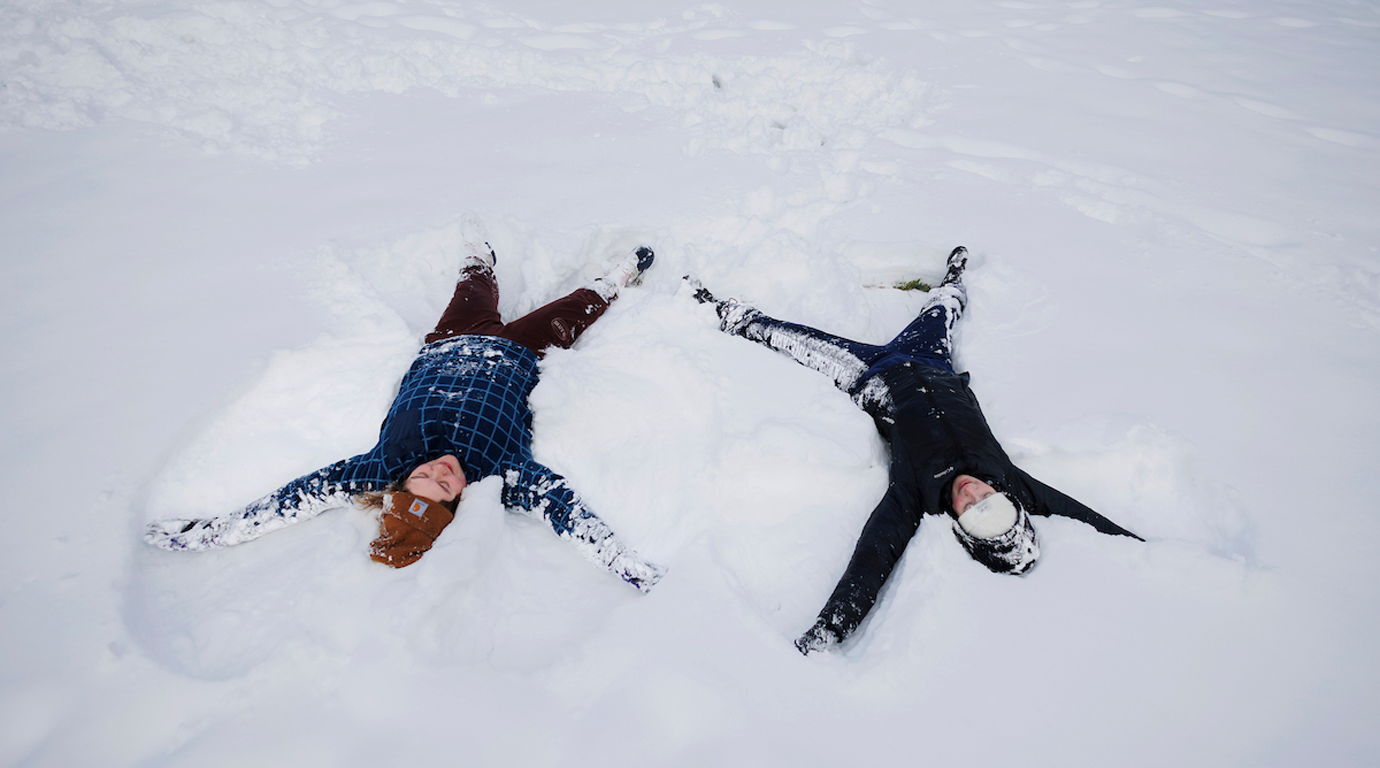 Two students studying outside the library at a picnic table