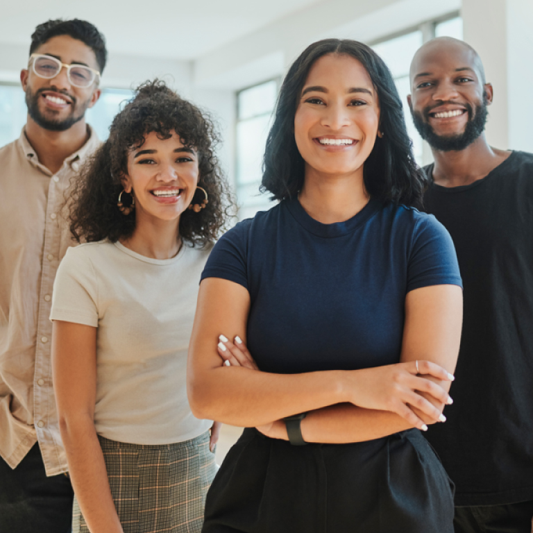 A group of people standing together and smiling.